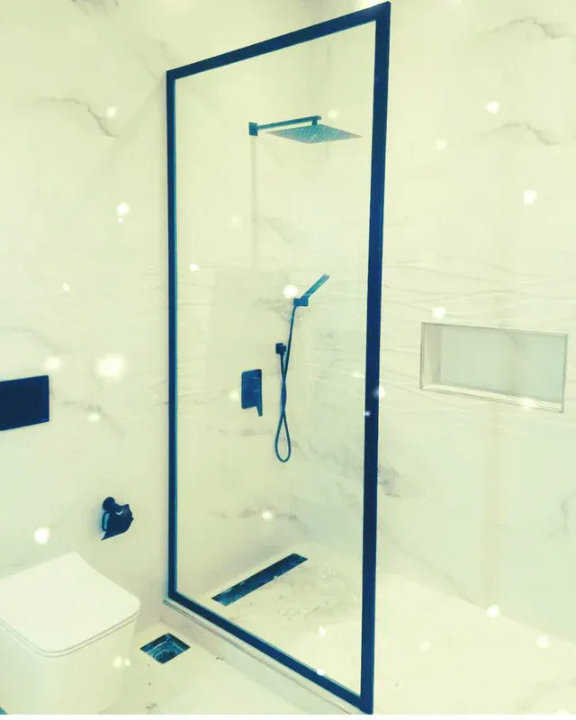 Bespoke luxury matte black fixed glass shower partitions custom-fabricated and flush-fitted for a luxury master bathroom at The Pearl-Qatar by Al Najm glass and mirror.