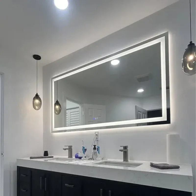 Premium oversized horizontal rectangular smart bathroom mirror featuring a dual-zone illuminated inner LED light border and ambient backlighting custom installed by Al Najm Glass and Mirror over a dark double vanity in Doha, Qatar.
