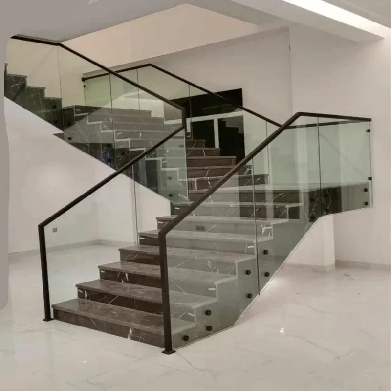 Bespoke glass stair railing in Qatar and modern office glass partition Doha layout by Al Najm Glass & Mirror Company. Contemporary commercial or residential multi-story staircase balustrade system engineered with structural safety glass and minimal architectural hardware.